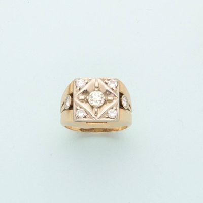 a close up of a gold ring with a diamond in the center