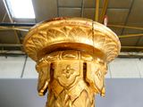 a gold statue of a man with a hat on it ' s head
