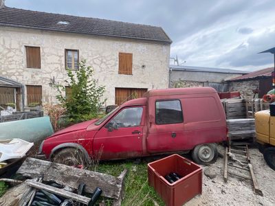 a red van that is parked in front of a building