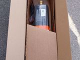 a cardboard box with a bottle in it on the ground