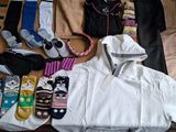 many pairs of socks and clothes laid out in a suitcase