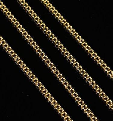 a close up of a gold chain on a black background
