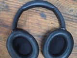 a pair of black headphones on a wooden table