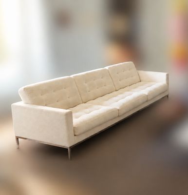 a white couch sitting on a table in a living room