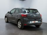 the back end of a grey car parked in a showroom