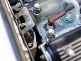 a close up view of a motorcycle engine with a hose