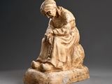 an image of a statue of a man sitting on top of a rock