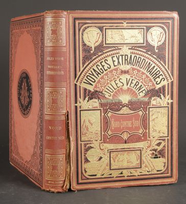 an old book sitting on top of a table next to a black background