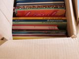 cardboard box full of children ' s books sitting on top of a table