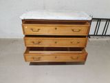 a marble top dresser with three drawers on it