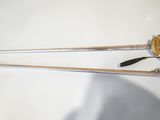 two swords that are laying next to each other on a table