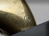 a close up of a bronze sculpture of a person holding a knife