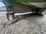 underside view of a green and white boat with a chain attached to it