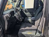 the interior of a vehicle with the door open and the driver ' s seat up