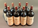 six bottles of wine are lined up in a row on a table