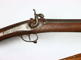 two old guns are displayed on a white surface with a white background