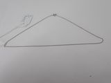 a silver necklace with a chain attached to it on a white surface