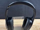 a pair of headphones sitting on top of a wooden table