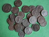 a lot of coins that are on a green surface