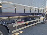 a large truck with a tarp on the back of it