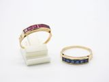 two rings and a ring stand on a white surface