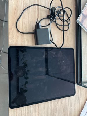a tablet computer sitting on top of a wooden table