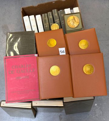 several books are stacked on top of each other in a box