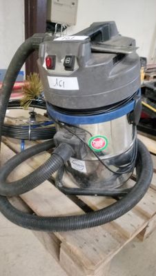 a vacuum that is sitting on a pallet in a room