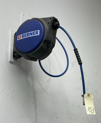 a blue hose attached to a wall with a tag attached to it
