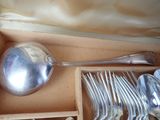 silverware in a box with a spoon, spoon and spoon rest in it