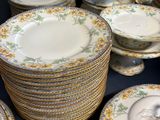 a lot of plates and bowls that are on a table