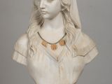 marble bust of a woman wearing a headdress on a table