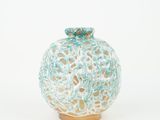 a white and blue vase sitting on a white surface