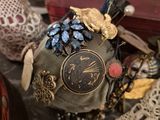 a small clock sitting on top of a table next to other items