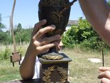 a man that is putting something on a vase