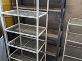 many shelves that are in the corner of a room