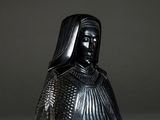 a black statue of a woman with a veil on her head