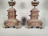 pair of antique bronze vases on pedestals on a white background