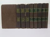 six books are lined up in a row on a white surface