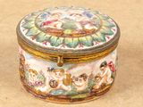 a small box with a painting on it sitting on a table