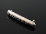 an image of a small silver object on a black surface