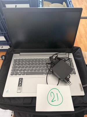 a laptop computer sitting on top of a black bag