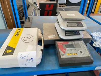 many different types of weighing on a table in a warehouse