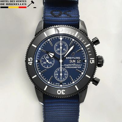 a close up of a watch with a blue strap