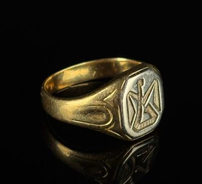 a gold signet ring with the initials of two men