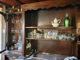 a wooden cabinet with glassware on top of it