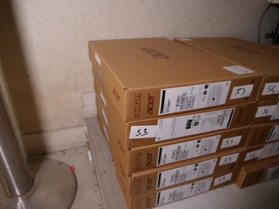 a stack of boxes sitting on the floor next to a metal pipe