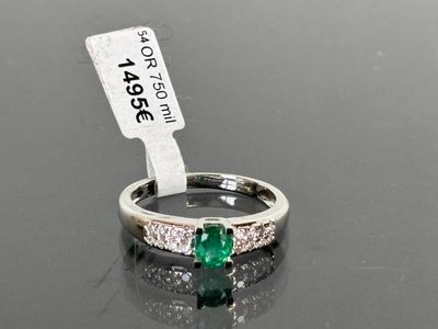 an image of a ring with a green stone