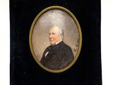an old picture of a man in a black suit and tie