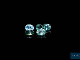 a pair of blue and green diamonds on a black background